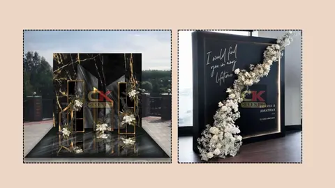 Black and gold layered floral backdrop and flower-trimmed welcome panel
