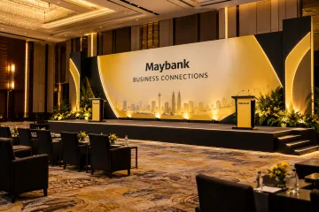 Maybank business summit with large summit stage wall, two lecterns and tidy guest seating rows