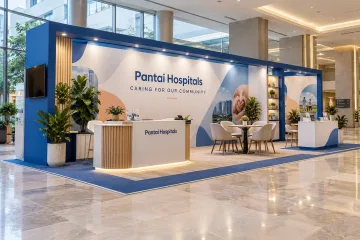 Pantai Hospitals community health awareness day with an open health-awareness roadshow booth with overhead blue frame, information counters and consultation seating