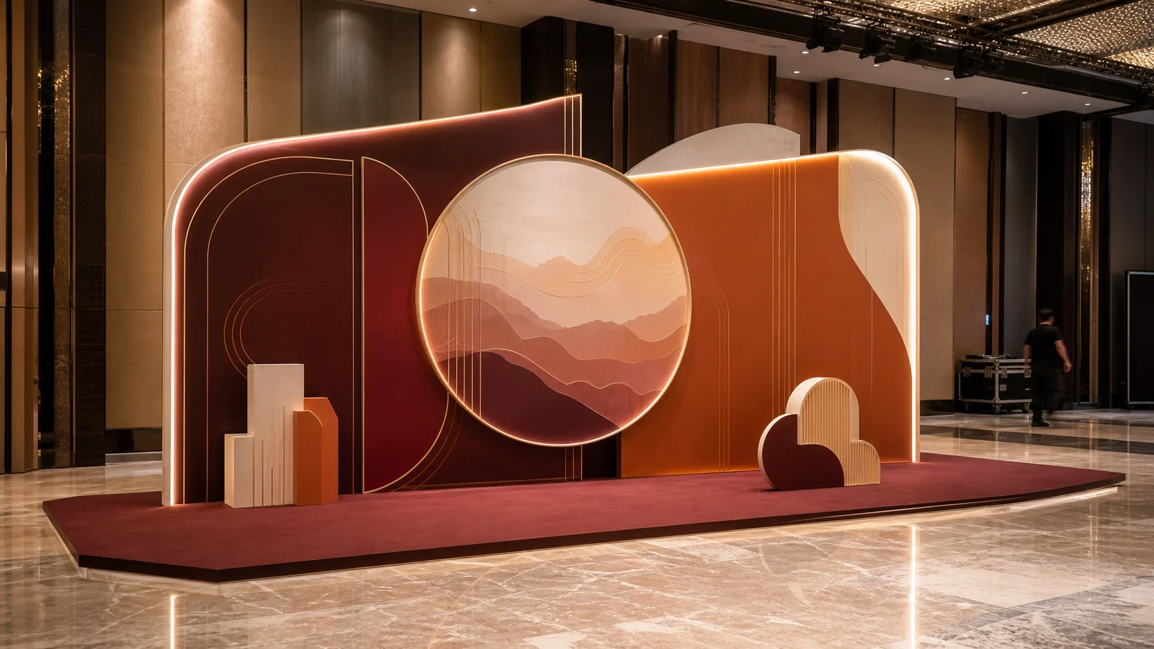 Burgundy and orange layered 3D annual-dinner backdrop concept in a Kuala Lumpur event hall