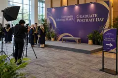 Universiti Teknologi MARA graduate portrait day design reference with campus graduation portrait wall and low group platform