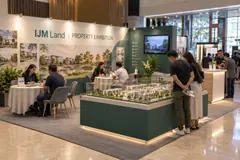 IJM Land property exhibition design reference with property showcase island and visitor discussion tables