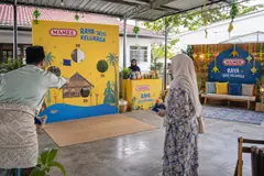 Mamee family raya gathering design reference with family raya games and photo area