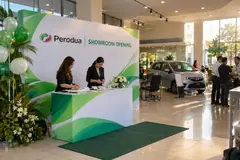 Perodua showroom opening design reference with showroom opening photo wall and welcome counter