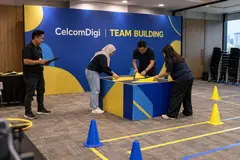 CelcomDigi team building design reference with indoor team-building relay and briefing wall